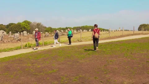 Carnac Megalithic Alignments - Visitors Exploring Prehistoric Standing Stones Stock Footage 322751817