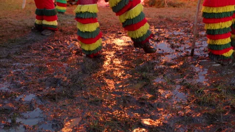 Carnival character jumps in the mud Stockbeeldmateriaal 268337805