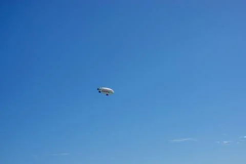 A Carnival Cruise Ship advertsing Blimp flying in a blue sky sunny day in Flo Stock Photos
