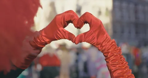 Carnival - Forming a heart shape with the hands. OTS. Handheld shot. Slow-mo. Stock-Footage 263884972