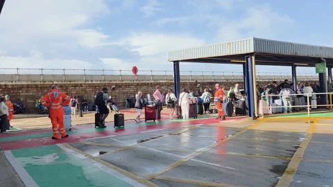Carnival Legend passengers at Dover Cruise Port with port workers and luggage Stock Footage 346798677