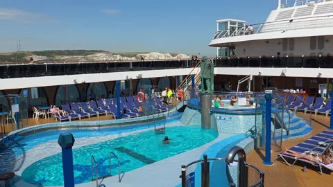 Carnival Legend pool deck with White Cliffs of Dover visible beyond the ship in Stock Footage 346798776