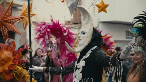 Carnival Performer Wearing Crescent Moon Mask During Festive Street Parade 스톡 동영상 332208968