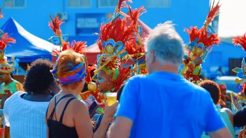 Carnival performers dance past crowd of parade spectators, slow motion Stock Footage 117425083