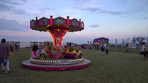 Carnival ride merry-go-round at sunset Stockbeeldmateriaal 78160271