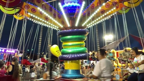 Carnival Swing Ride At Night In Motion, Adults, Teenagers, Children Having Fun Stock Footage 237676416