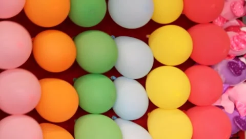 Carnival theme park games balloon pop dart game Stock Footage 6827679