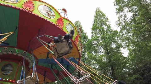 Carousel against trees and sky Stock Footage 128287810