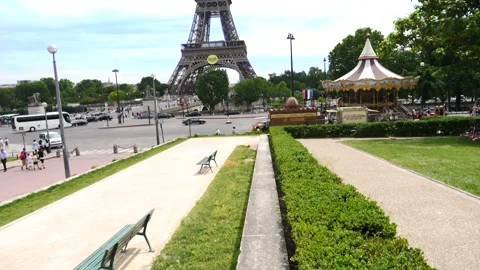 A carousel and a curb-stone pointing to the Eiffel Tower, Paris, France Stock Footage 237923897