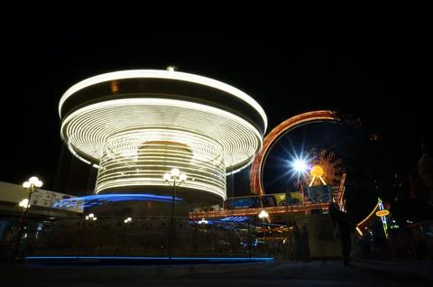 Carousel attraction in the night in action Stock Photos