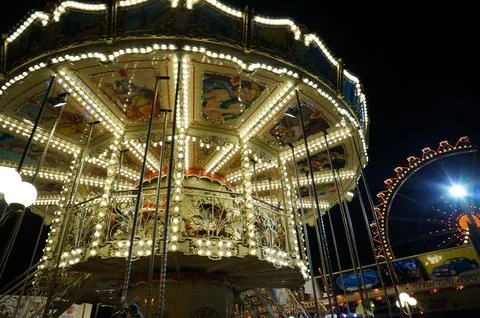 Carousel attraction in the night in action Фото