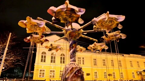 Carousel on the background of the night city, rotates from a strong wind. Stock Footage 127774748