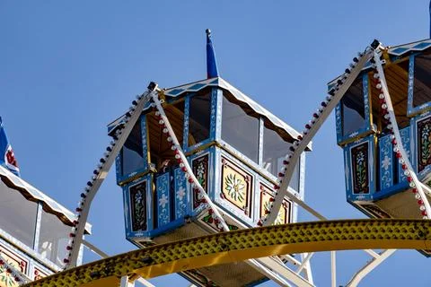 A carousel with a blue and white carousel car with a blue top Stock Photos