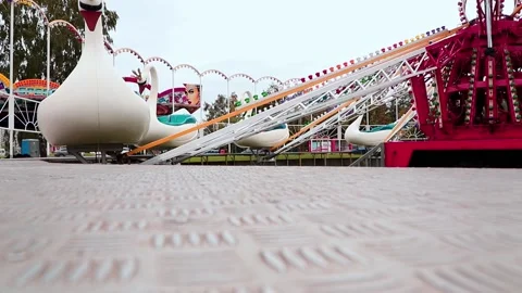 Carousel for children Swans in motion in the amusement park Stock Footage 197364604