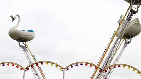 Carousel for children Swans in motion in the amusement park Stock Footage 197364655