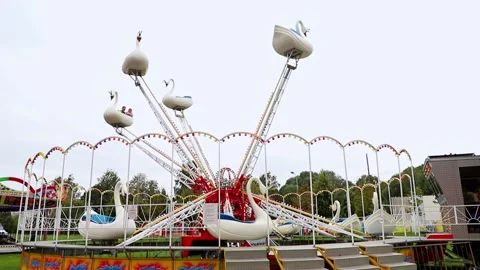Carousel for children Swans in motion in the amusement park Stock Footage 197364664