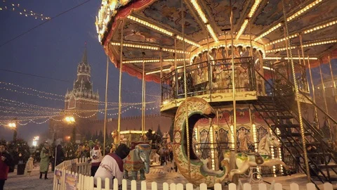The carousel at the Christmas fair on Red Square in Moscow during a snowstorm Stock Footage 120806507