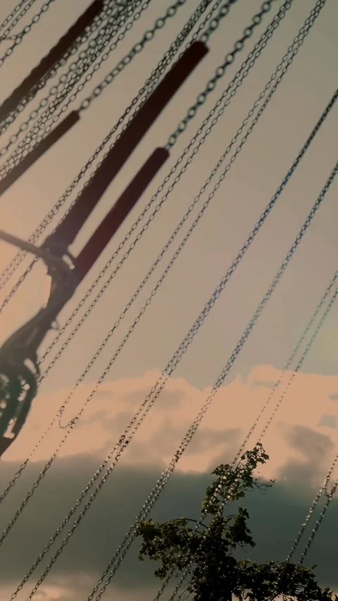 Carousel. Close-up. Fair park. Rotating carousel. Soft sunlight. Swing ride at Stock Footage 315090728