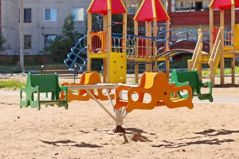 Carousel, colored slides and ladders at children playground Stock Photos