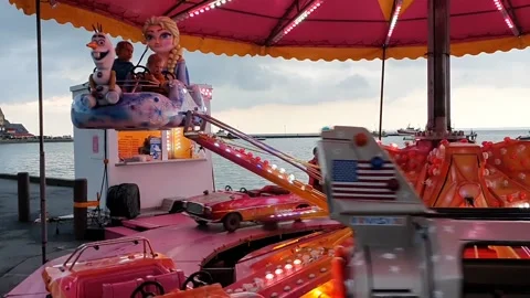 A carousel with flashy lights during a fair by the sea Stock Footage 158997654