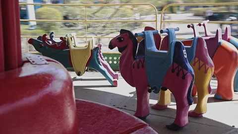 Carousel for kids with animals is spinning in an amusement park Stock Footage 291328985