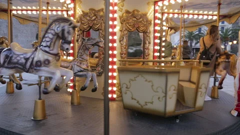 Carousel for kids, with galloping horses, at amusement park or fairground Stock Footage 167659882
