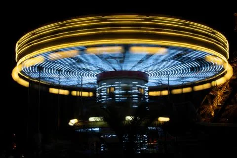 Carousel (merry-go-round) time lapse photo shot in late evening light at a Stock Photos