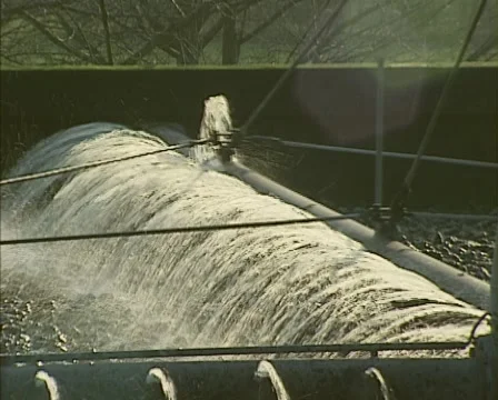 Carousel moving across lava bed, spraying wastewater, biological filtration Stock Footage 47228311