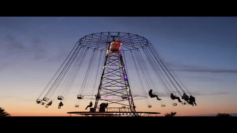 Carousel is spinning Children ride on the carousel against blue sunset sky Stock Footage 331194576