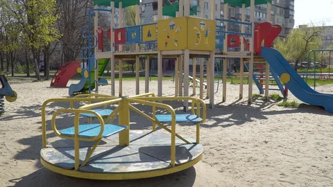 Carousel is spinning on the children's playground Stock Footage 127816443