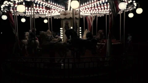 A carousel is spinning in a night park Stock Footage 91586438