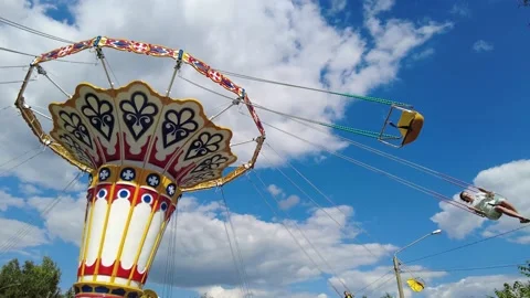 The carousel is spinning in the park, the carousel on chains is spinning people Stock Footage 203881600