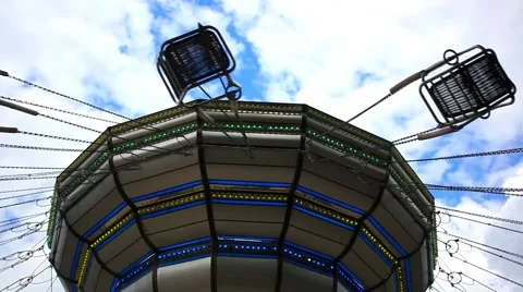 Carousel spinning on sky background with clouds. HD. 1920x1080 Video stock 46959372