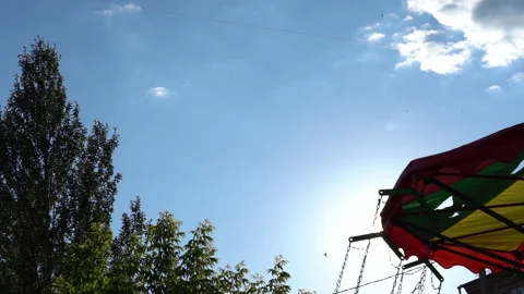 The carousel spins against the sky Stock Footage 221184454