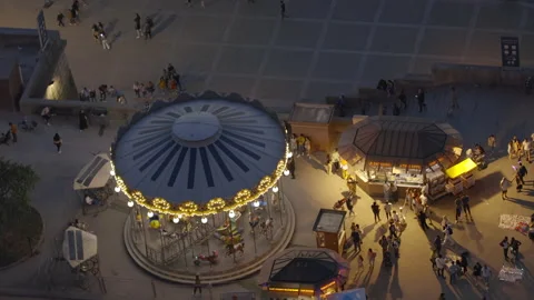 Carousel turning seen from the Eiffel Tower on a spring evening in Paris, France Stock Footage 198194564