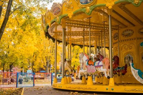 Carousel with warm lights during a summer evening near the sea Stock Photos