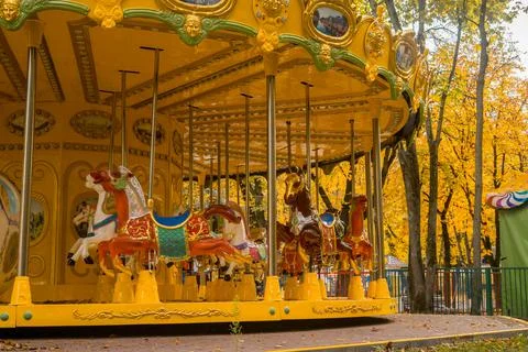 Carousel with warm lights during a summer evening near the sea Stock Photos