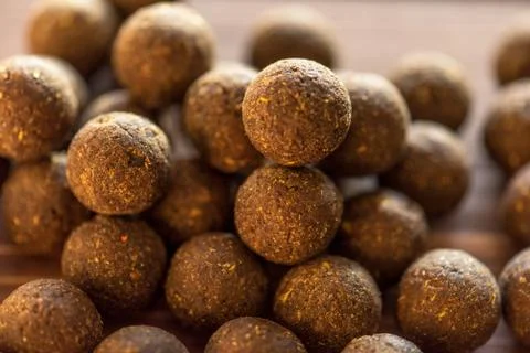 Carp baits on a wooden background. Stock Photos