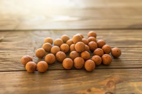 Carp baits on a wooden background. Stock Photos