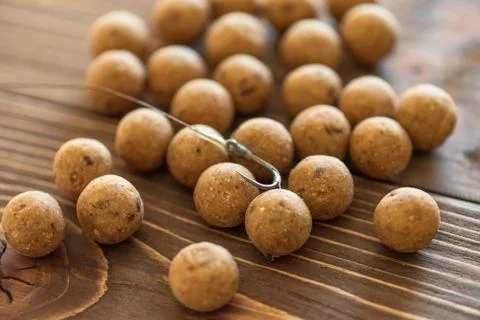 Carp baits on a wooden background. Stock Photos