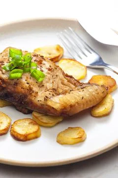 Carp on cumin with fried potatoes Stock Photos