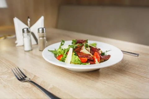 Carpaccio plates ready to serve on the table. Carpaccio in a white bowl on a Stock Photos
