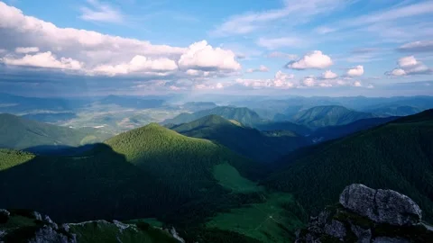 Carpathians mountain range timelapse with moving clouds, sunbeams lighting green 스톡 동영상 313593724
