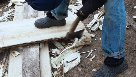 Carpenter aligns the edge of the Board with an ax. Stock Footage 108575028