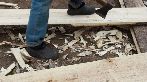 Carpenter aligns the edge of the Board with an ax. Stock Footage 108575033