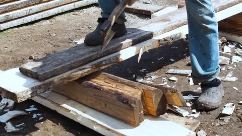 Carpenter aligns the edge of the Board with an ax. Stock Footage 108712971