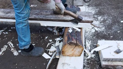 Carpenter aligns the edge of the Board with an ax. Stock Footage 108764337
