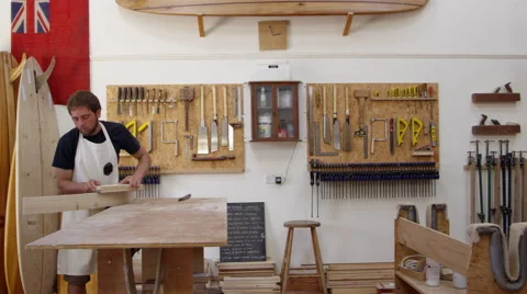 Carpenter And Apprentice Make Surfboards Shot On RED Camera Stock Footage 64349860