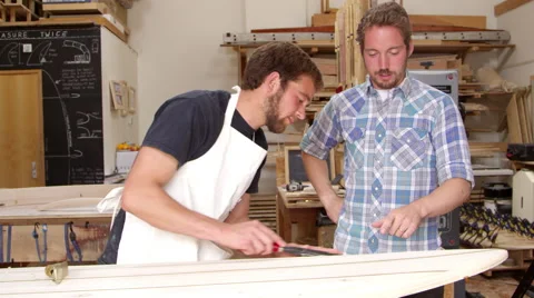 Carpenter And Apprentice Make Surfboards Shot On RED Camera Stock-Footage 64350072