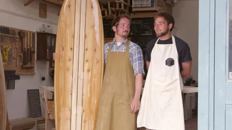 Carpenter And Apprentice With Surfboard Shot On RED Camera Stock Footage 64350031